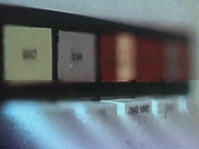 Proper Audacity glitch of 1960s vintage computer footage. Up close shots are of a magnetic tape machine; a hand pressing play on a tape machine; a hand flipping a switch on a computer control panel. Glitches form like fractures: red, magenta, blue, cyan.